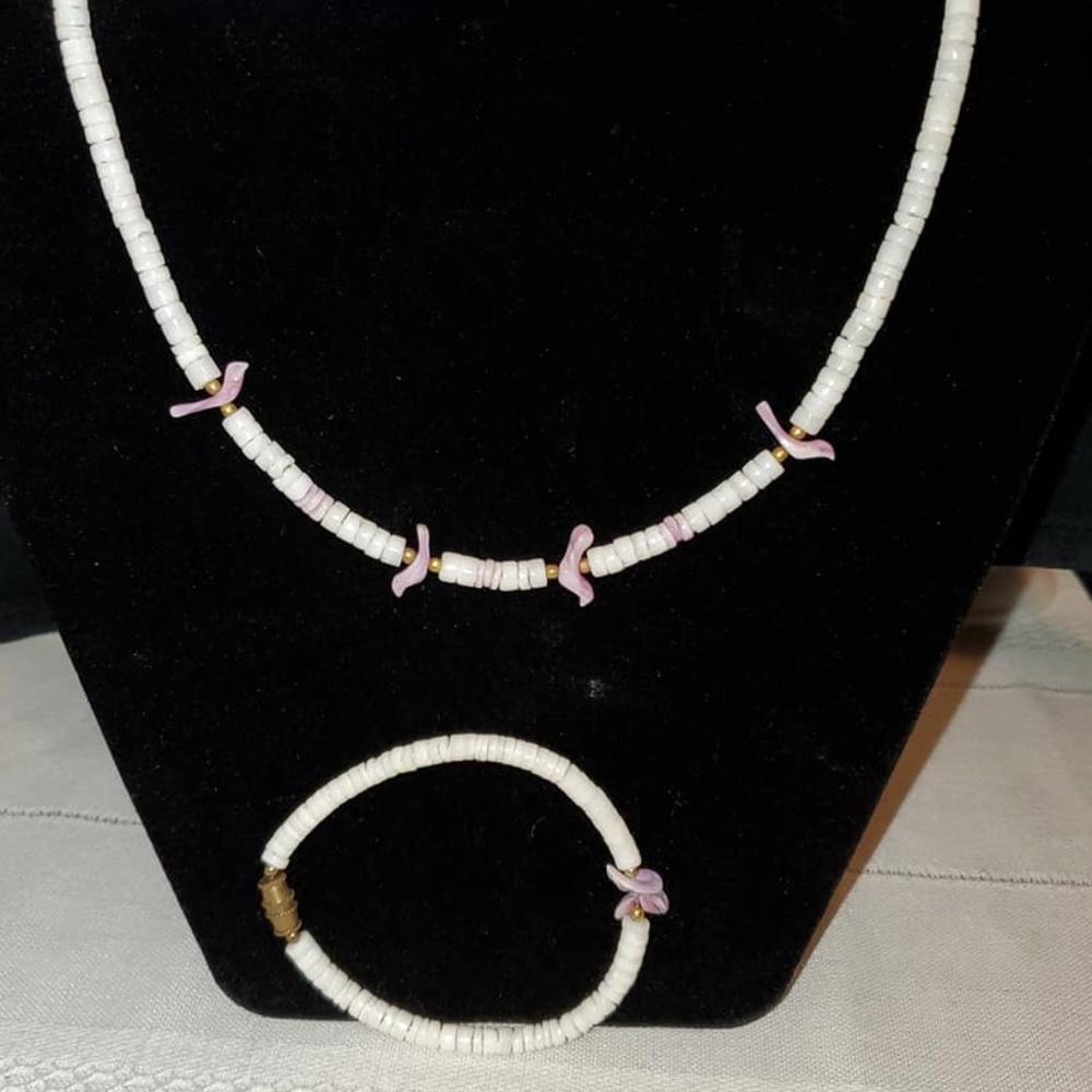 White shell bead necklace with purple bird charms